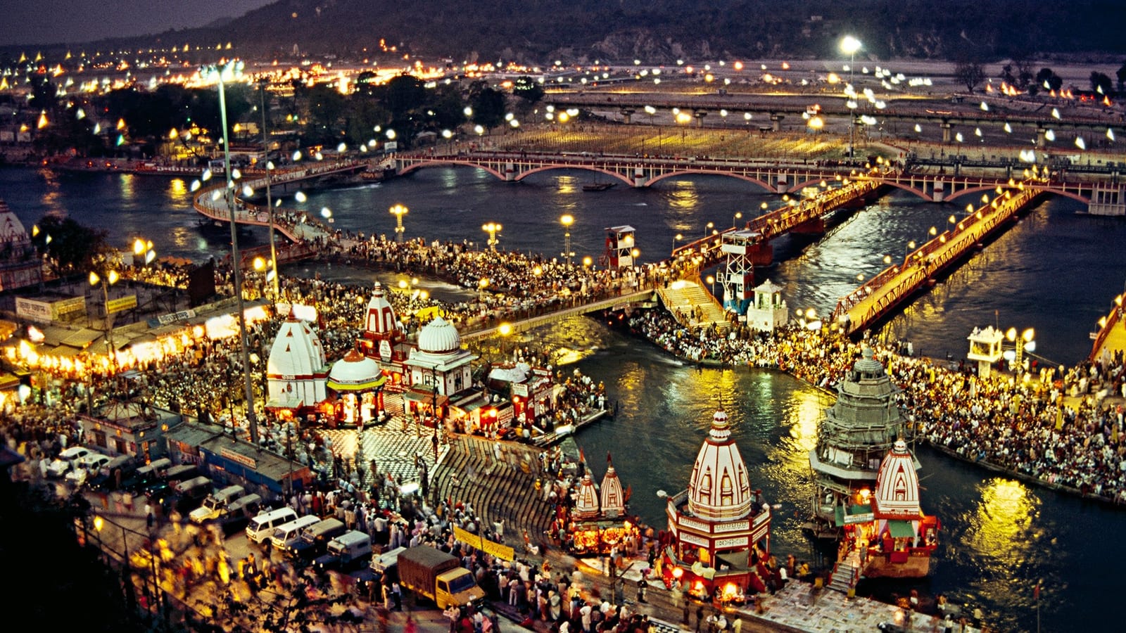 The ghats of Rishikesh lit up at night beside the Ganges
