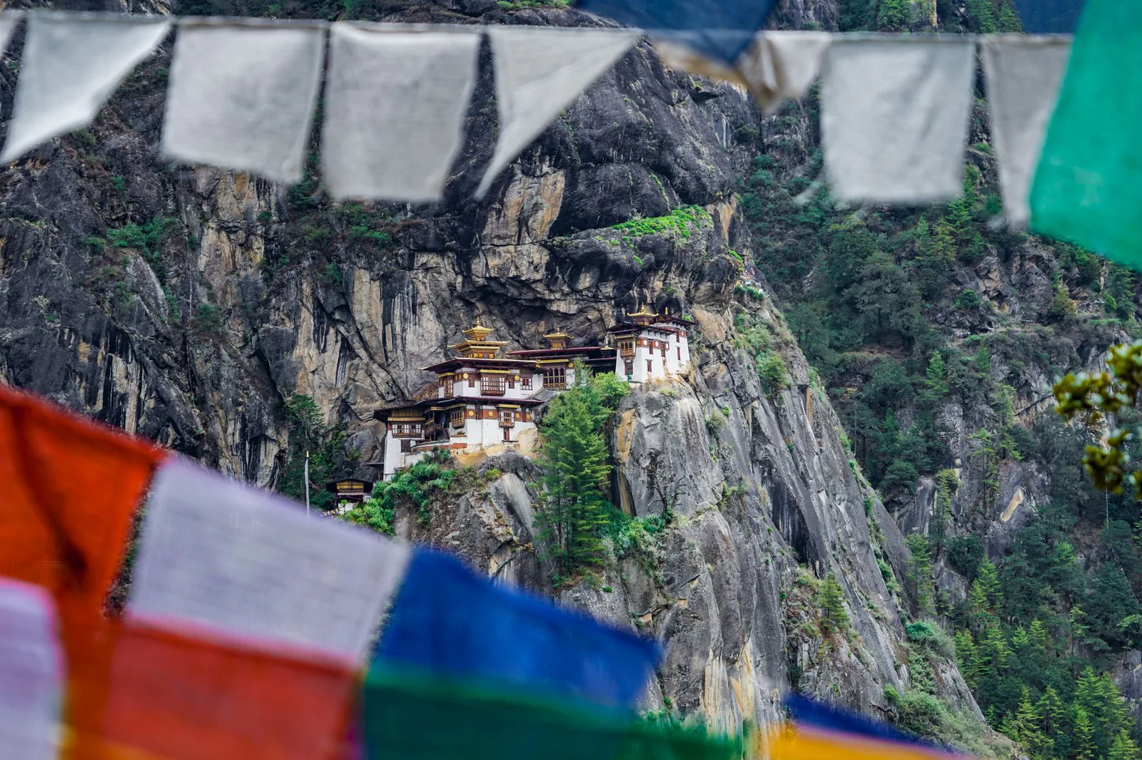 Tiger's Nest Monastery (Paro Taktsang) on a cliff in Bhutan with prayer flags — India, Nepal & Bhutan: The Himalayan Trilogy