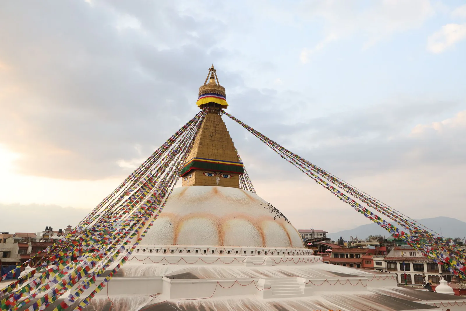 Boudhanath Stupa in Kathmandu with prayer flags at sunrise