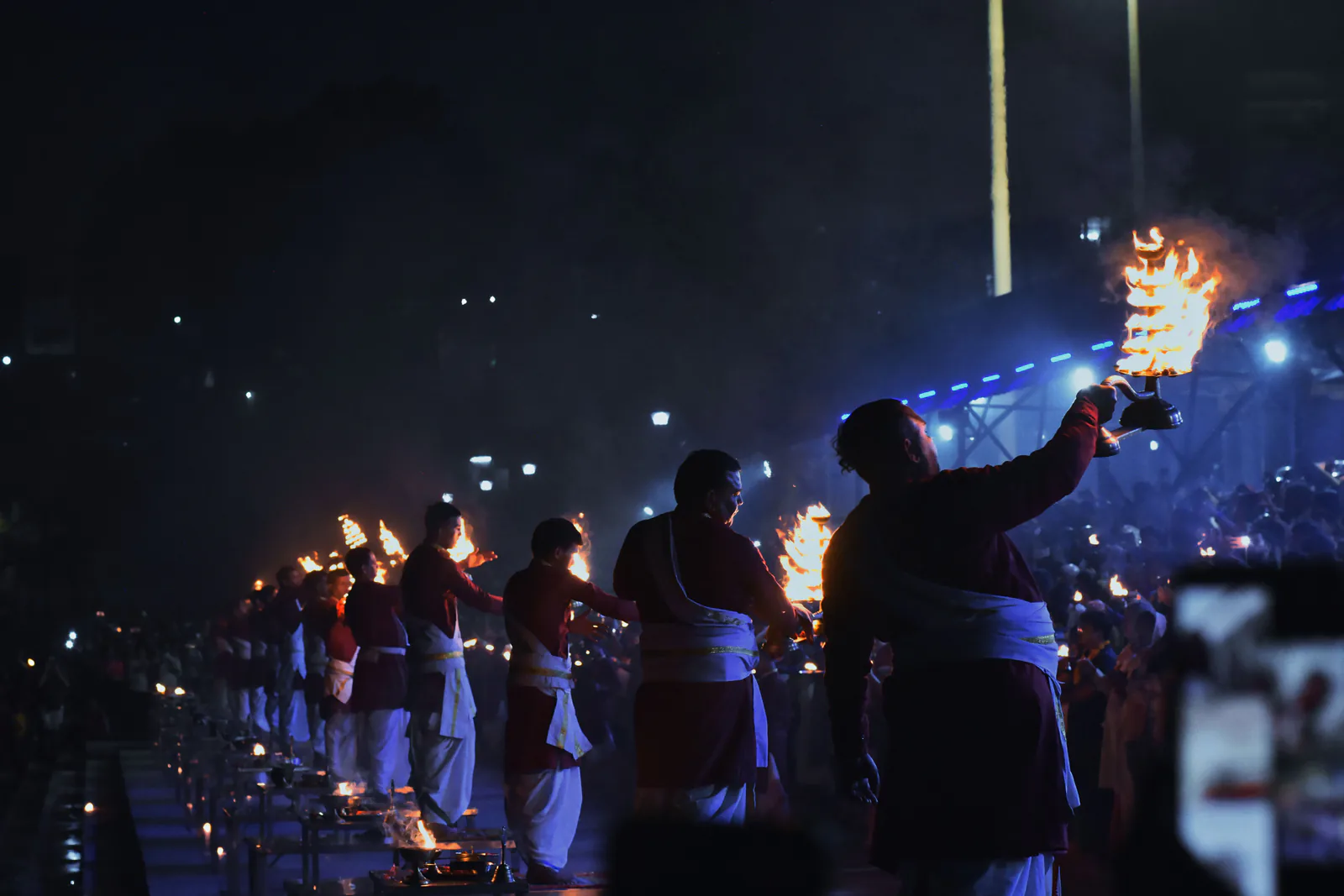Flames rising during a sacred ceremony beside the Ganges in the evening