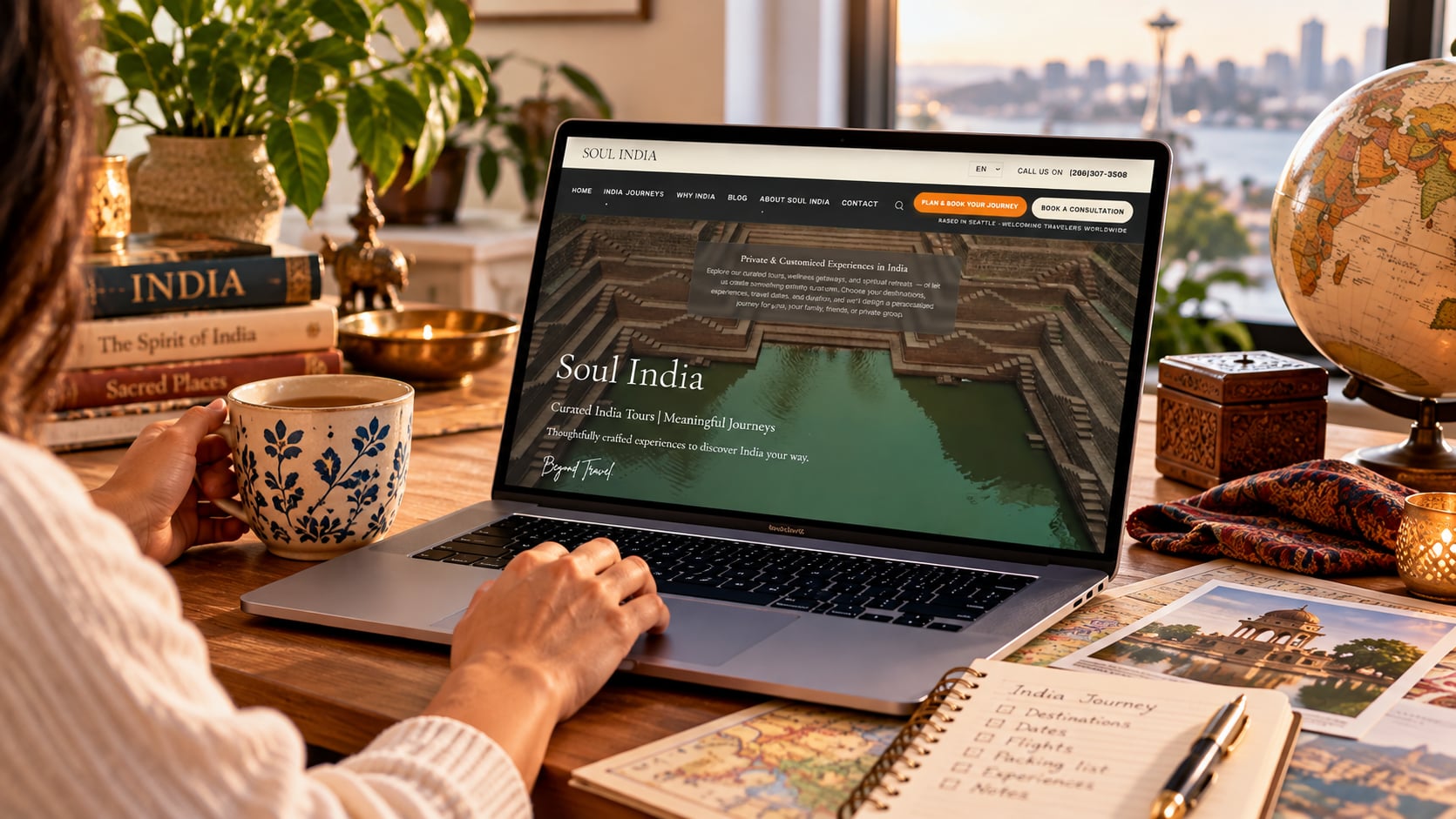 Traveler booking her journey to India on a laptop with a golden-hour view of Indian architecture