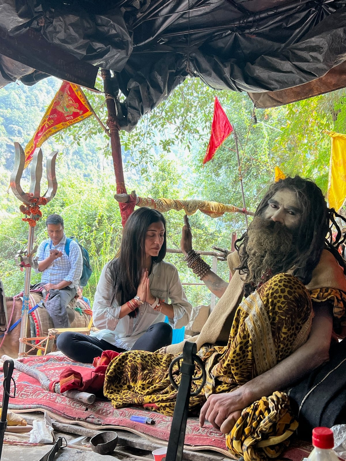 The founder of Soul India Journeys sitting beside sadhu Kedargiri at his dhuni during the Kedarnath pilgrimage.